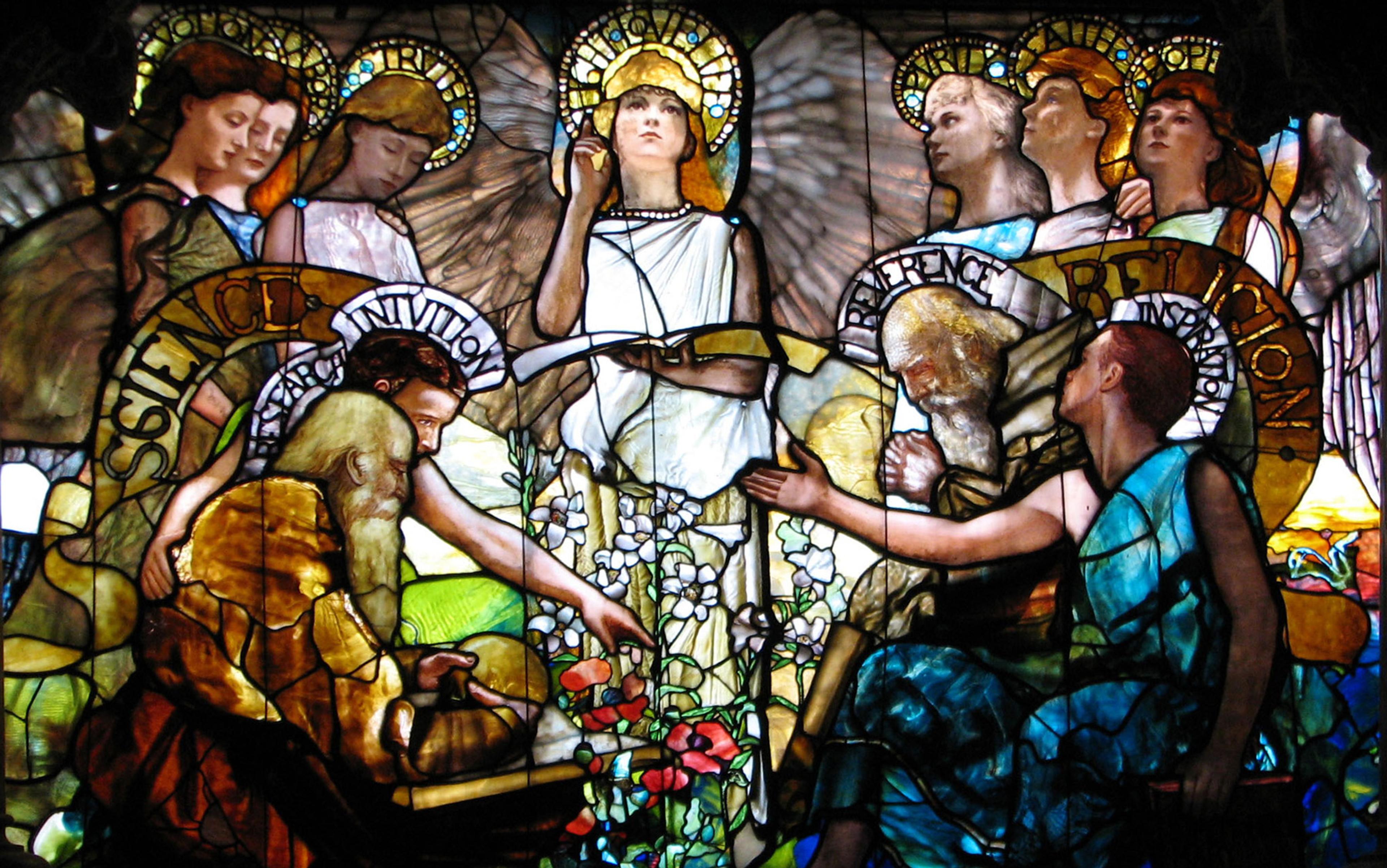 Stained glass window depicting various figures with halos engaged in learning and reflection, surrounded by flowers and inscriptions.